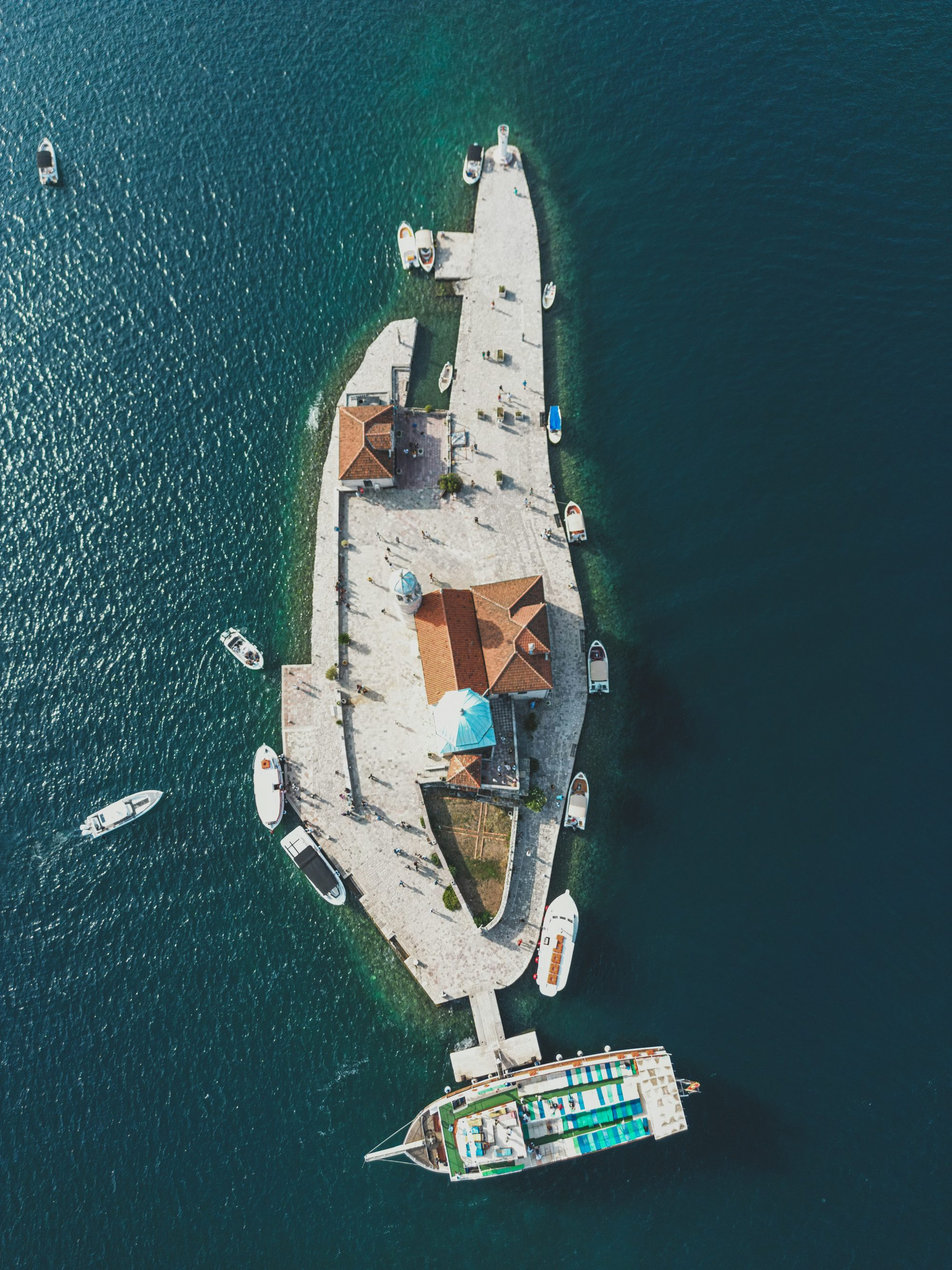 Our Lady of the Rocks island seen from above with boats around it